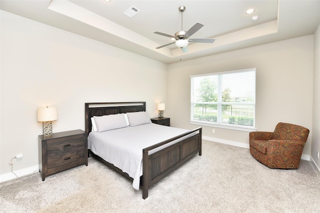 22911 Pearl Glen Dr, Richmond, TX 77469 - bedroom featuring a tray ceiling, light colored carpet, baseboards, a ceiling fan, and recessed lighting