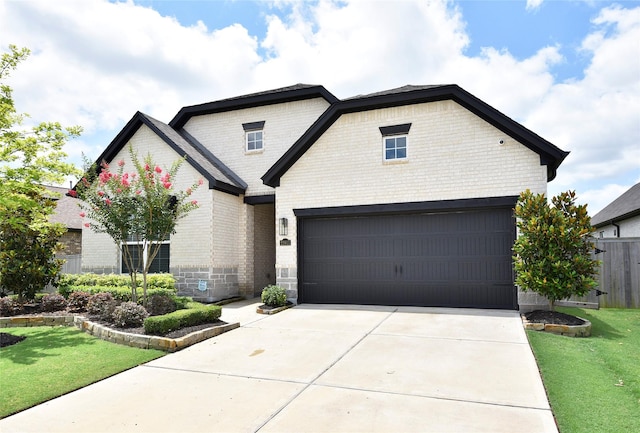 22911 Pearl Glen Dr, Richmond, TX 77469 - french country inspired facade featuring brick siding, an attached garage, and concrete driveway
