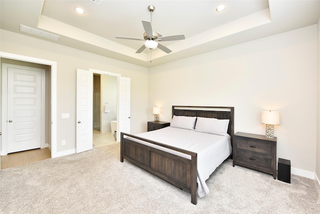 22911 Pearl Glen Dr, Richmond, TX 77469 - bedroom featuring a tray ceiling, carpet floors, baseboards, recessed lighting, and ensuite bath