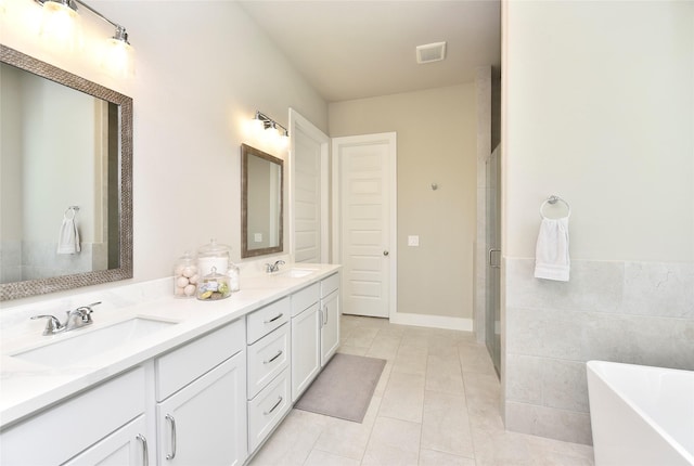 22911 Pearl Glen Dr, Richmond, TX 77469 - bathroom featuring a soaking tub, double vanity, tile patterned flooring, and a shower stall