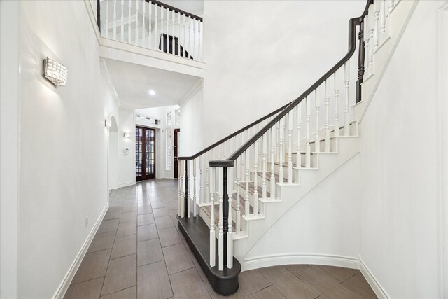 4111 Thistle Hill Ct, Sugar Land, TX 77479 - foyer with stairs, baseboards, ornamental molding, and a towering ceiling
