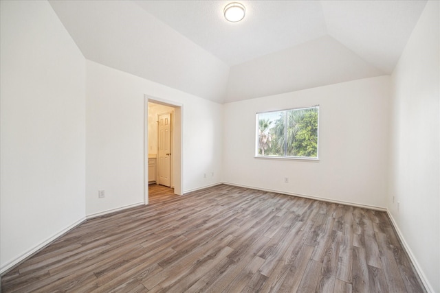 4111 Thistle Hill Ct, Sugar Land, TX 77479 - unfurnished bedroom featuring light wood-type flooring, vaulted ceiling, and baseboards
