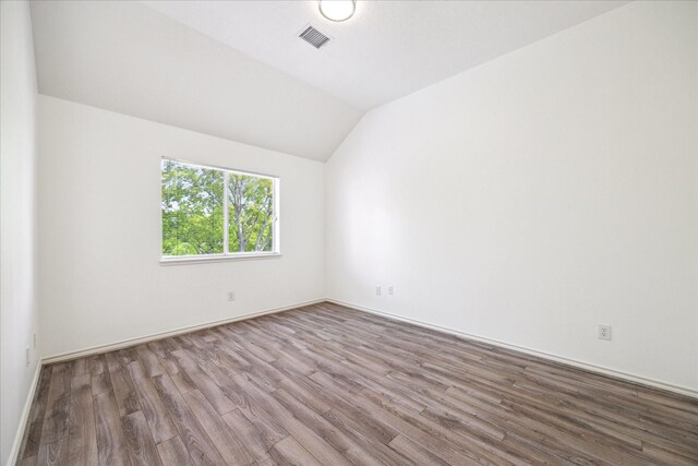 4111 Thistle Hill Ct, Sugar Land, TX 77479 - spare room with wood finished floors, vaulted ceiling, and baseboards
