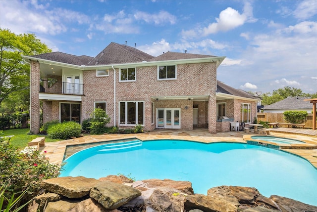 4111 Thistle Hill Ct, Sugar Land, TX 77479 - view of swimming pool featuring french doors, a patio area, and a pool with connected hot tub