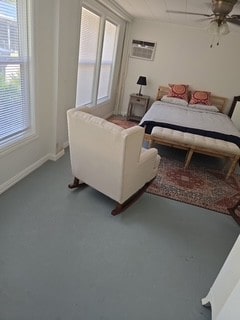 480 Johnson Rd, Coldspring, TX 77331 - bedroom featuring an AC wall unit, ceiling fan, and baseboards