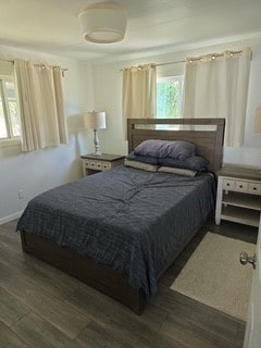 480 Johnson Rd, Coldspring, TX 77331 - bedroom with multiple windows, wood finished floors, and baseboards