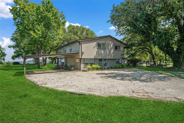 480 Johnson Rd, Coldspring, TX 77331 - back of house with a carport, driveway, and a yard