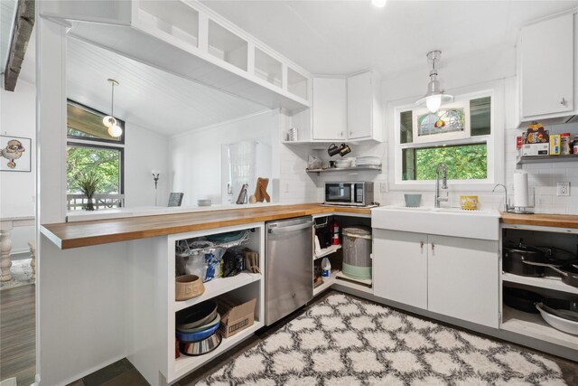 480 Johnson Rd, Coldspring, TX 77331 - kitchen with open shelves, butcher block countertops, stainless steel appliances, and a sink