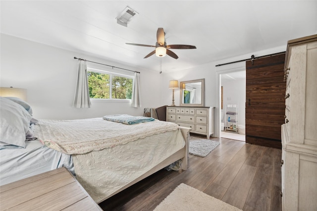 480 Johnson Rd, Coldspring, TX 77331 - bedroom featuring a barn door, wood finished floors, and ceiling fan