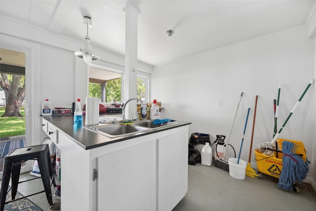 480 Johnson Rd, Coldspring, TX 77331 - kitchen featuring a sink, white cabinetry, dark countertops, concrete flooring, and ornamental molding