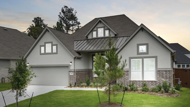 12834 Forest Garden Ct, Conroe, TX 77302 - view of front facade featuring brick siding, stucco siding, a standing seam roof, concrete driveway, and a shingled roof