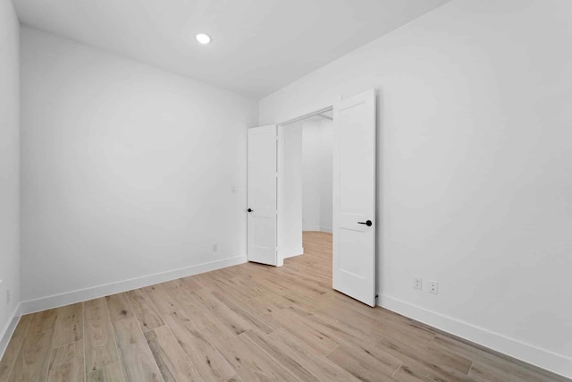 12834 Forest Garden Ct, Conroe, TX 77302 - unfurnished bedroom with light wood-style floors, baseboards, and recessed lighting
