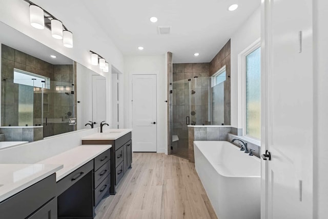12834 Forest Garden Ct, Conroe, TX 77302 - bathroom with plenty of natural light, a shower stall, vanity, a soaking tub, and recessed lighting