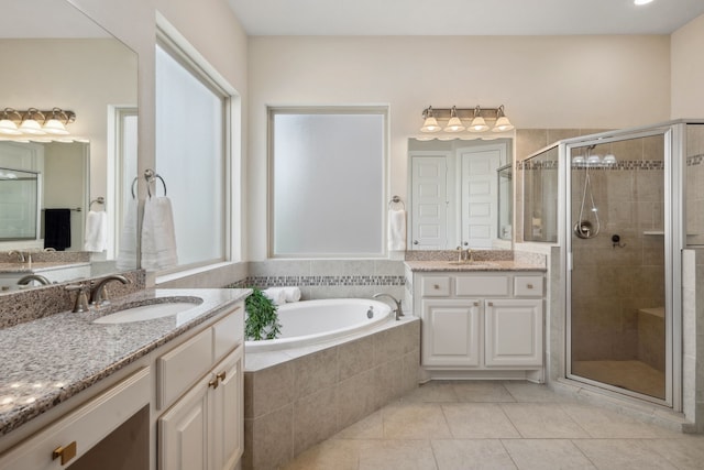 4051 Ashland Woods Dr, Spring, TX 77386 - full bathroom with two vanities, tile patterned floors, a stall shower, and a garden tub