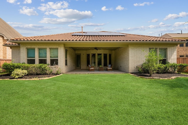 4051 Ashland Woods Dr, Spring, TX 77386 - back of property featuring a ceiling fan, a patio, solar panels, brick siding, and a tile roof
