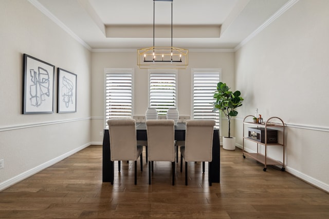 4051 Ashland Woods Dr, Spring, TX 77386 - dining space with a raised ceiling, a chandelier, wood finished floors, baseboards, and ornamental molding