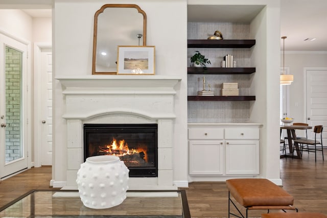 4051 Ashland Woods Dr, Spring, TX 77386 - living room featuring dark wood finished floors, a glass covered fireplace, and crown molding