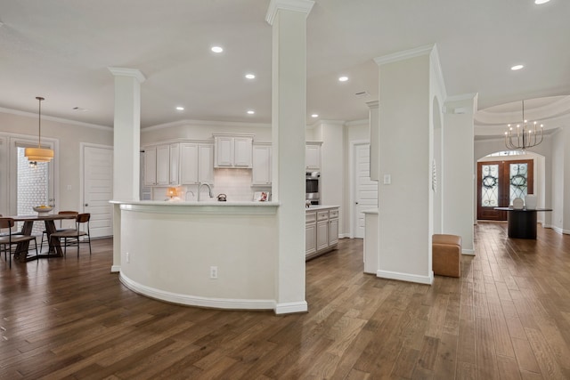 4051 Ashland Woods Dr, Spring, TX 77386 - kitchen with dark wood-style flooring, oven, light countertops, decorative backsplash, and ornamental molding