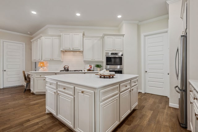 4051 Ashland Woods Dr, Spring, TX 77386 - kitchen featuring freestanding refrigerator, dark wood-style flooring, crown molding, tasteful backsplash, and white cabinets