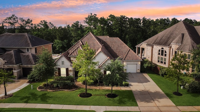 4051 Ashland Woods Dr, Spring, TX 77386 - view of front of house with driveway, a tile roof, a garage, and a lawn