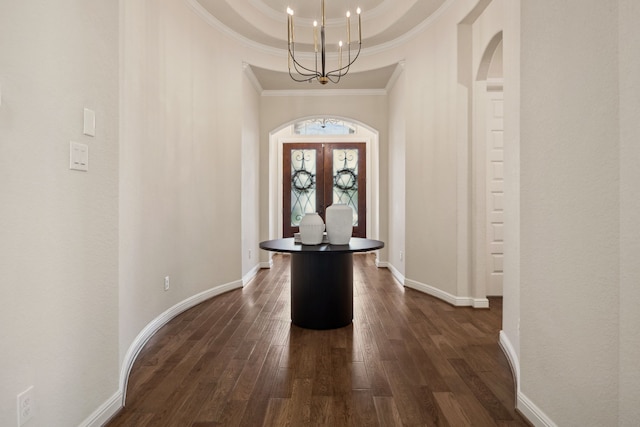 4051 Ashland Woods Dr, Spring, TX 77386 - foyer featuring arched walkways, dark wood finished floors, a chandelier, crown molding, and french doors