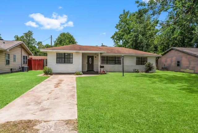 7280 Click Dr, Beaumont, TX 77708 - view of front of home with central air condition unit, driveway, and a front yard