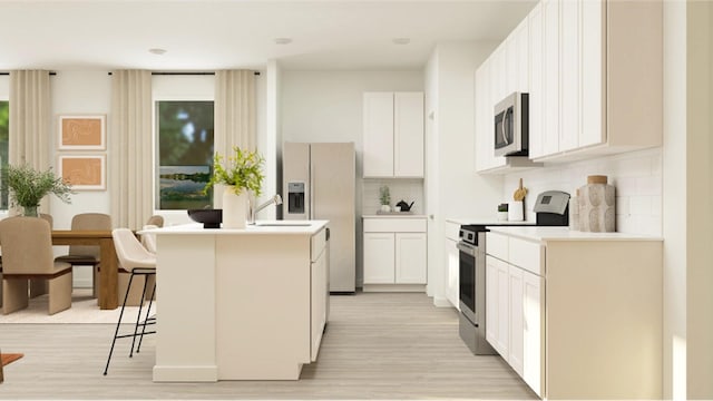 301 Tejas Trl, Waller, TX 77484 - kitchen with appliances with stainless steel finishes, decorative backsplash, an island with sink, light wood-style flooring, and white cabinetry