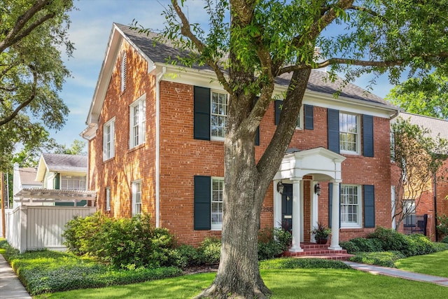 2256 Dryden Rd, Houston, TX 77030 - view of front of home featuring brick siding, a front yard, and roof with shingles