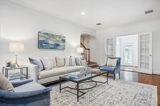 2256 Dryden Rd, Houston, TX 77030 - living area featuring ornamental molding, wood finished floors, arched walkways, baseboards, and stairs