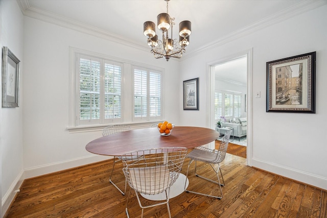 2256 Dryden Rd, Houston, TX 77030 - dining room featuring crown molding, baseboards, a chandelier, and wood finished floors