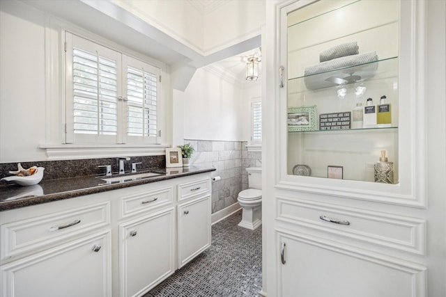 2256 Dryden Rd, Houston, TX 77030 - bathroom with vanity, tile walls, toilet, a wainscoted wall, and crown molding