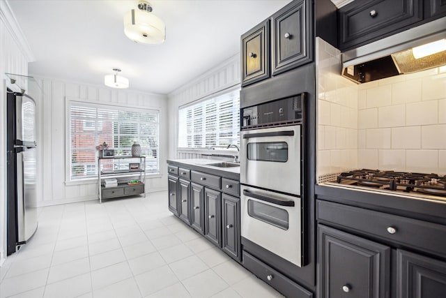 2256 Dryden Rd, Houston, TX 77030 - kitchen with double oven, ornamental molding, fridge, gas stovetop, and a sink