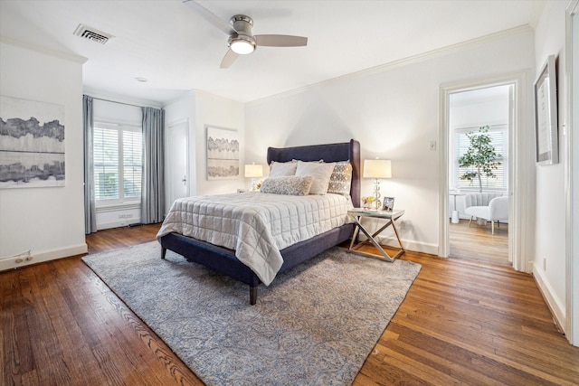 2256 Dryden Rd, Houston, TX 77030 - bedroom with crown molding, wood finished floors, baseboards, and a ceiling fan