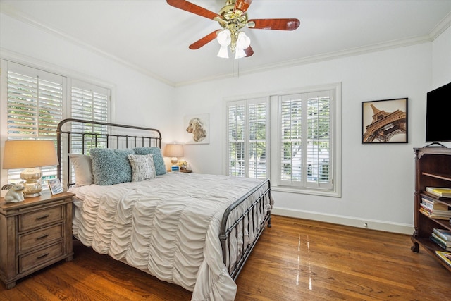 2256 Dryden Rd, Houston, TX 77030 - bedroom featuring multiple windows, dark wood-style flooring, baseboards, ornamental molding, and a ceiling fan