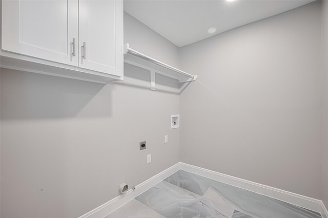 8314 Burning Hills Dr, Houston, TX 77071 - laundry room with hookup for an electric dryer, hookup for a washing machine, cabinet space, baseboards, and marble look tiles