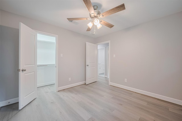 8314 Burning Hills Dr, Houston, TX 77071 - unfurnished bedroom with light wood-style flooring, baseboards, ceiling fan, and a closet