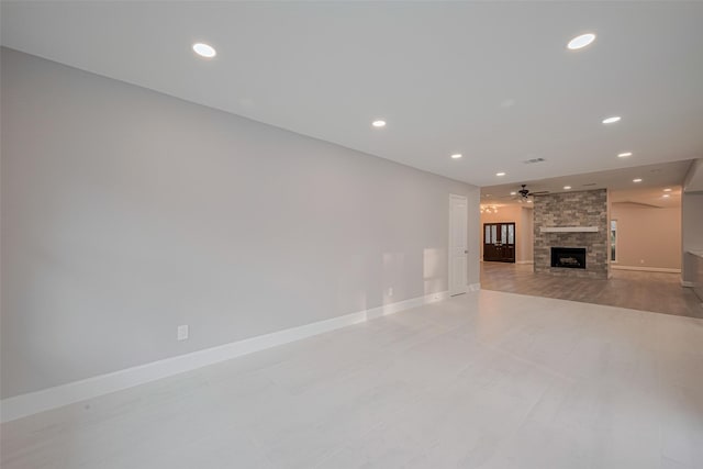 8314 Burning Hills Dr, Houston, TX 77071 - unfurnished living room featuring a stone fireplace, ceiling fan, baseboards, and recessed lighting