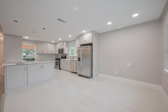 8314 Burning Hills Dr, Houston, TX 77071 - kitchen featuring appliances with stainless steel finishes, recessed lighting, decorative backsplash, plenty of natural light, and baseboards