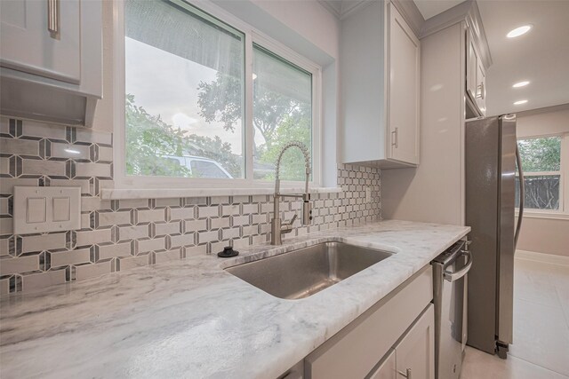 8314 Burning Hills Dr, Houston, TX 77071 - kitchen with stainless steel appliances, a sink, light stone counters, tasteful backsplash, and recessed lighting