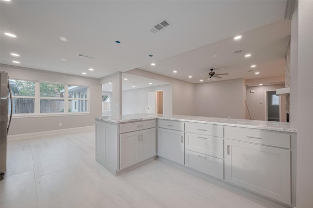 8314 Burning Hills Dr, Houston, TX 77071 - kitchen with open floor plan, light stone countertops, a ceiling fan, recessed lighting, and baseboards