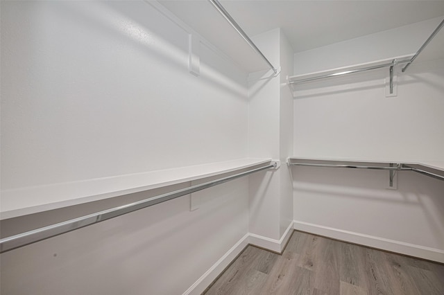 8314 Burning Hills Dr, Houston, TX 77071 - walk in closet featuring wood finished floors