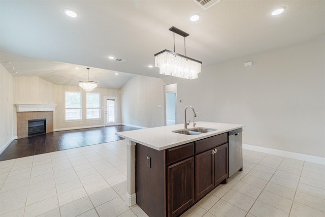 16719 Highland Country Dr, Cypress, TX 77433 - kitchen with a sink, dishwasher, light tile patterned floors, a chandelier, and lofted ceiling