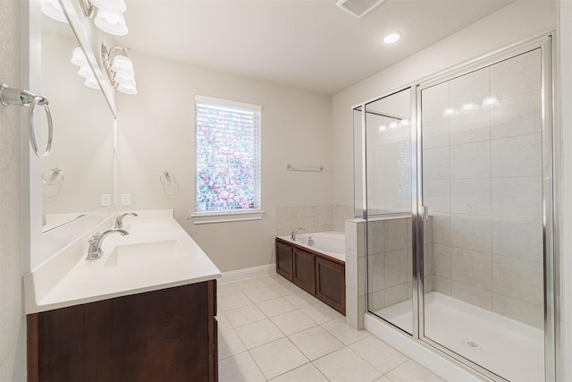 16719 Highland Country Dr, Cypress, TX 77433 - full bathroom with tile patterned flooring, a garden tub, vanity, baseboards, and a stall shower