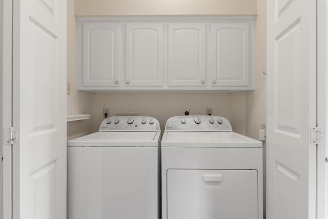 1327 Mission Chase Dr, Houston, TX 77077 - washroom featuring cabinet space and washing machine and dryer