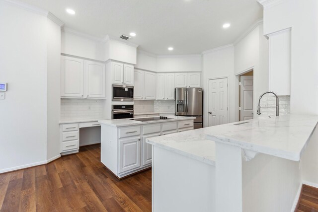 1327 Mission Chase Dr, Houston, TX 77077 - kitchen with appliances with stainless steel finishes, a peninsula, ornamental molding, light stone countertops, and a sink