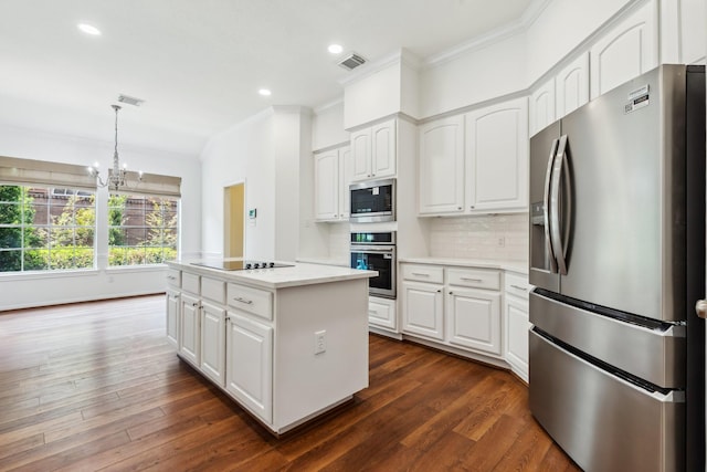 1327 Mission Chase Dr, Houston, TX 77077 - kitchen featuring appliances with stainless steel finishes, ornamental molding, a center island, tasteful backsplash, and light countertops