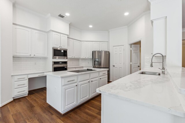 1327 Mission Chase Dr, Houston, TX 77077 - kitchen with stainless steel appliances, a sink, ornamental molding, light stone counters, and backsplash