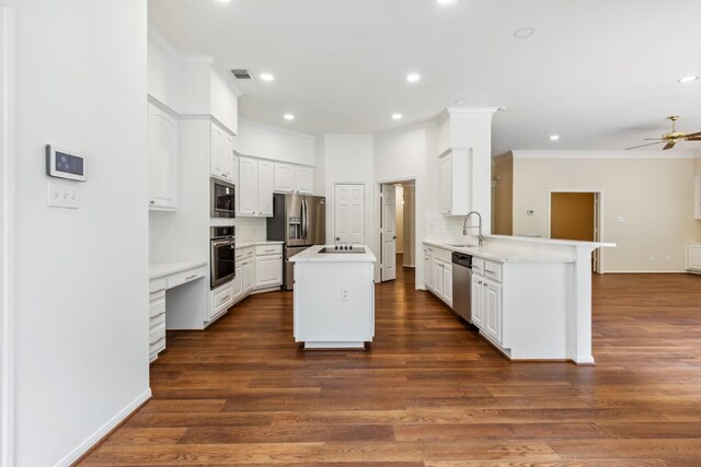 1327 Mission Chase Dr, Houston, TX 77077 - kitchen with stainless steel appliances, a sink, crown molding, a peninsula, and a kitchen island