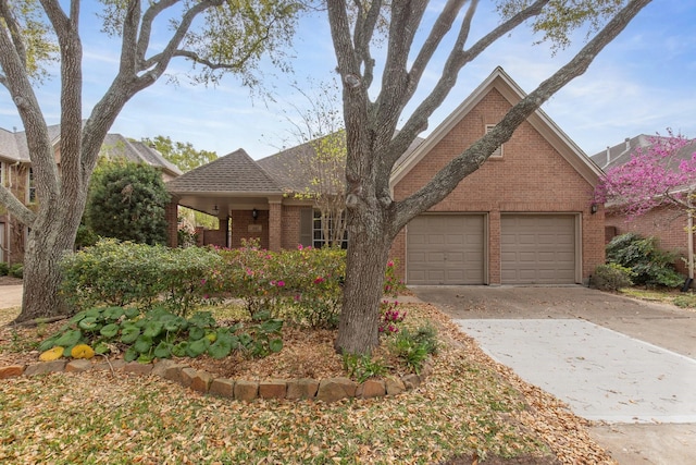 1327 Mission Chase Dr, Houston, TX 77077 - view of front of home with brick siding, an attached garage, and driveway