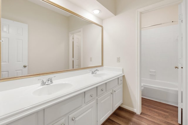 1327 Mission Chase Dr, Houston, TX 77077 - bathroom featuring double vanity, wood finished floors, baseboards, toilet, and shower / washtub combination